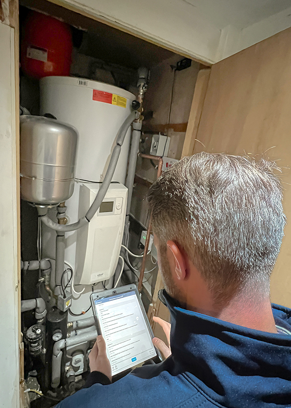 Routine boiler maintenance check on water heater tank