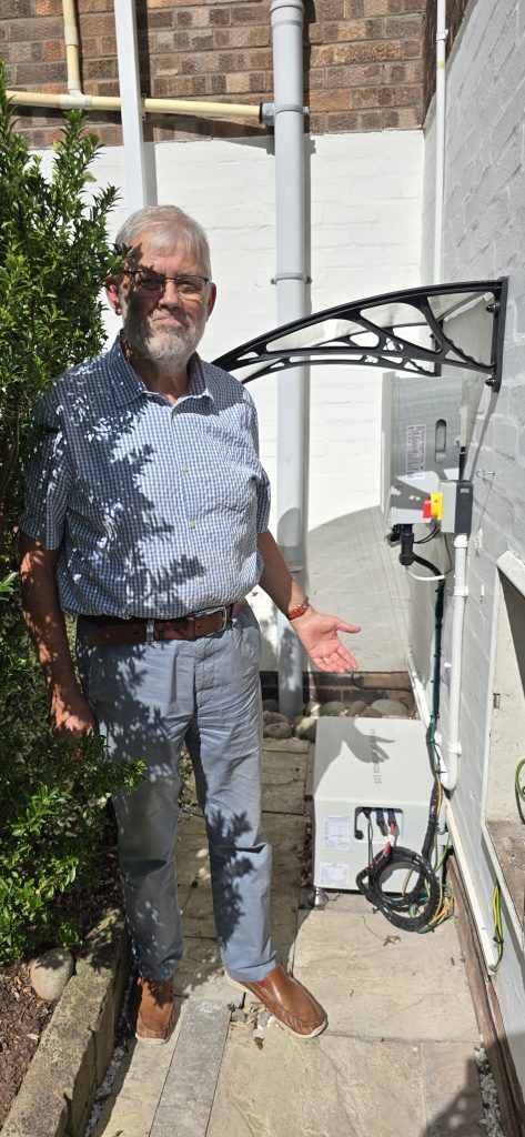 Solar Panel customer standing next to Fox ESS Battery and Inverter